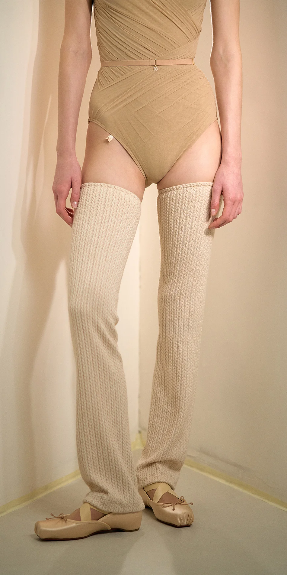 Knitted leg warmers in cream front view off