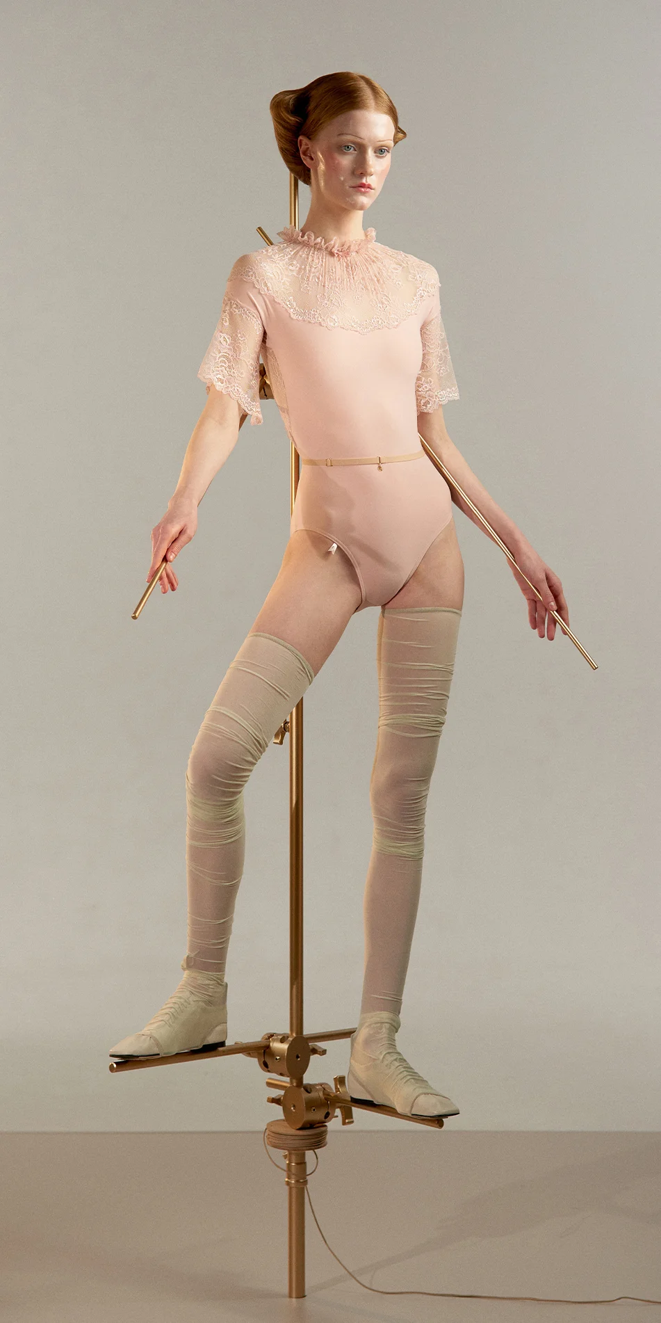 Mockneck leotard with bell sleeves in baby pink front view on