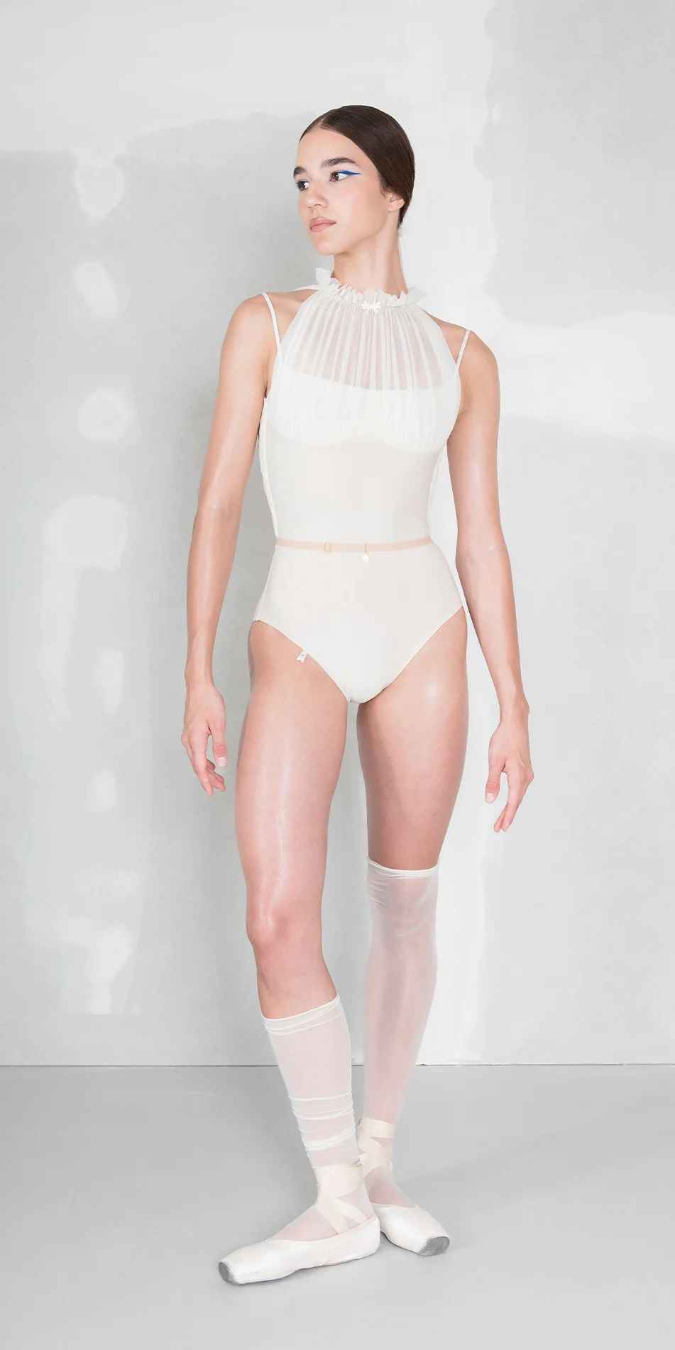 Draped mockneck leotard in cream front view