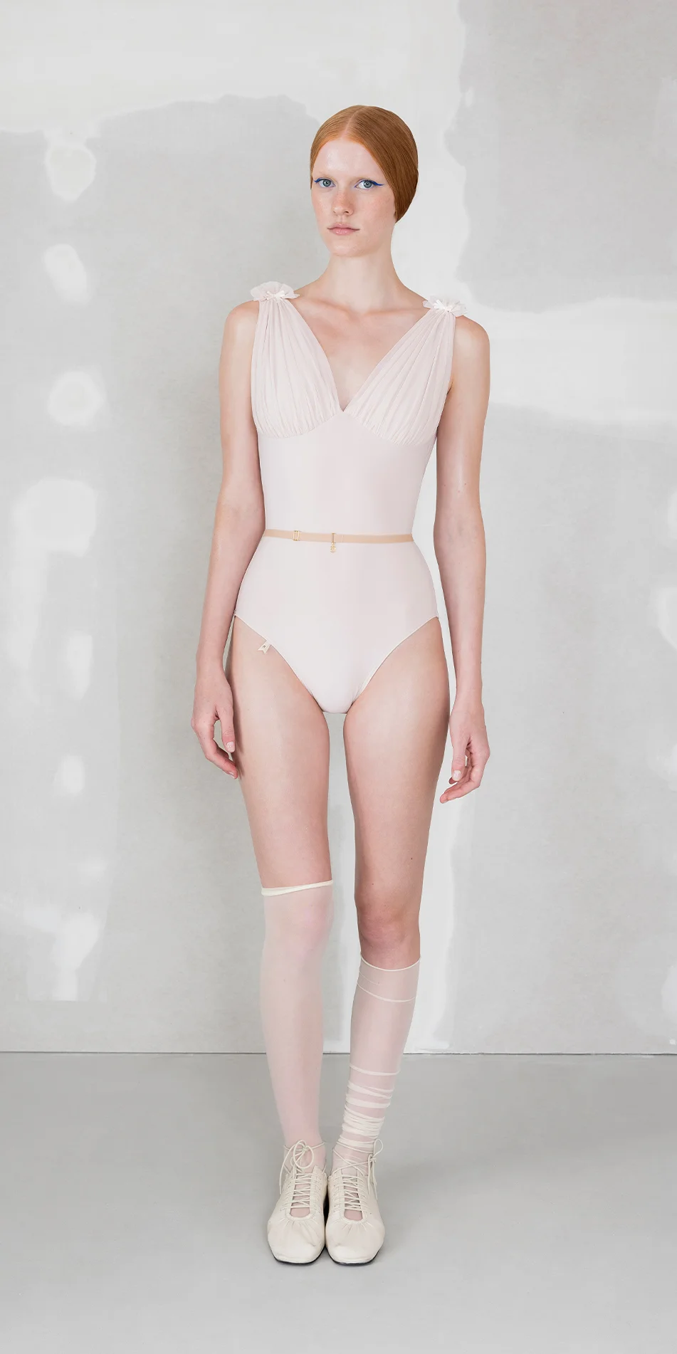 Draped split neck leotard in pearl pink front view