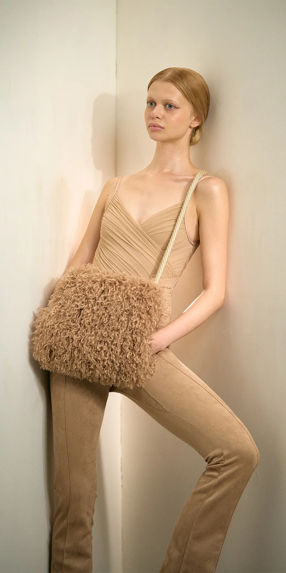 Faux fur muff crossbody bag nude front posing on