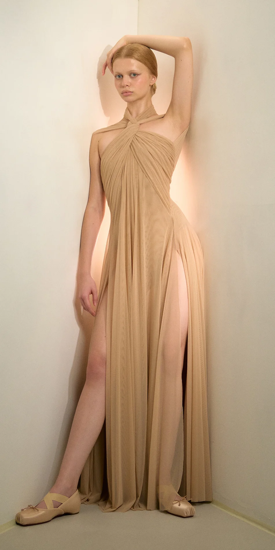 Knotted halter maxi dress in light beige front one arm up on