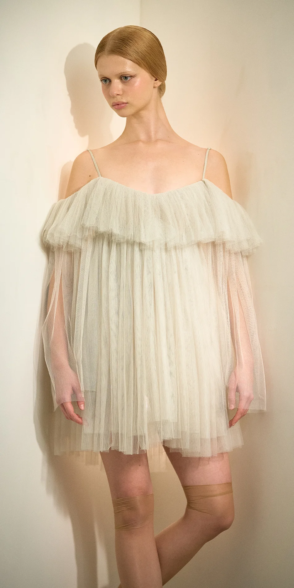 Tulle babydoll dress angel sleeves in sage green front arms down on