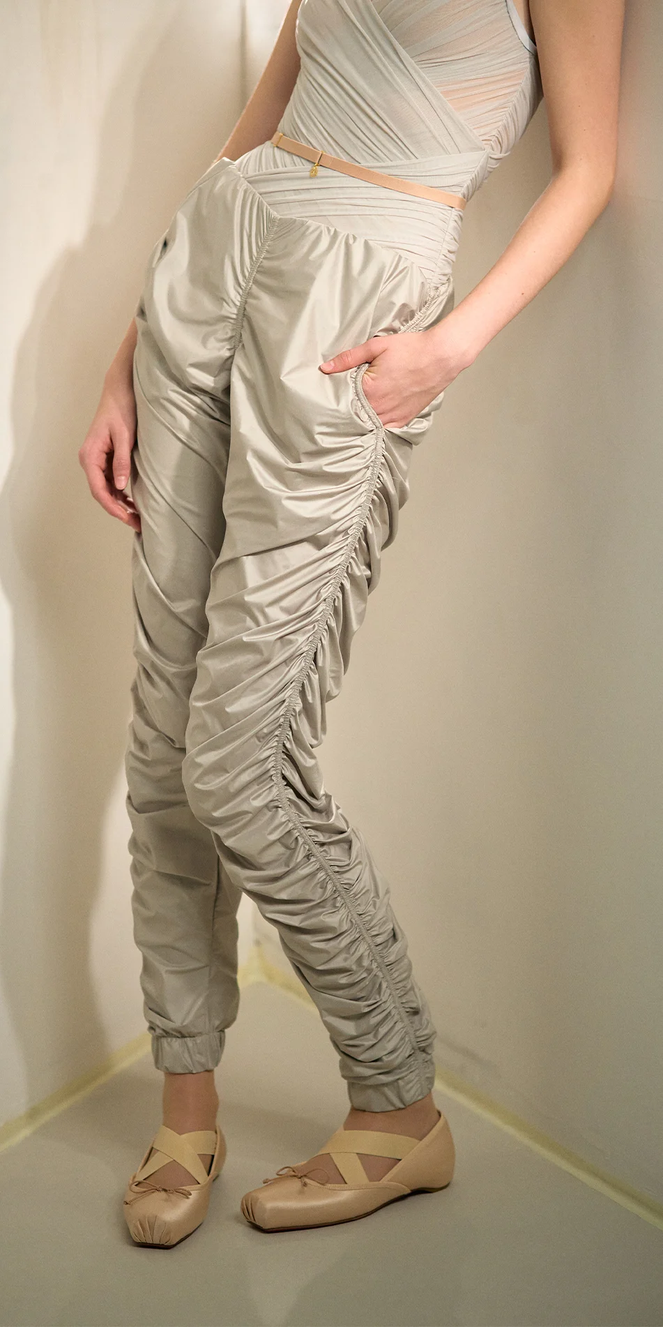 Women's draped track pants in sage green front view close up