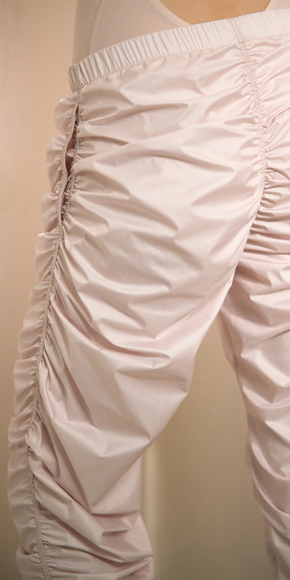 Womens draped track pants in soft pink close up of pocket from back