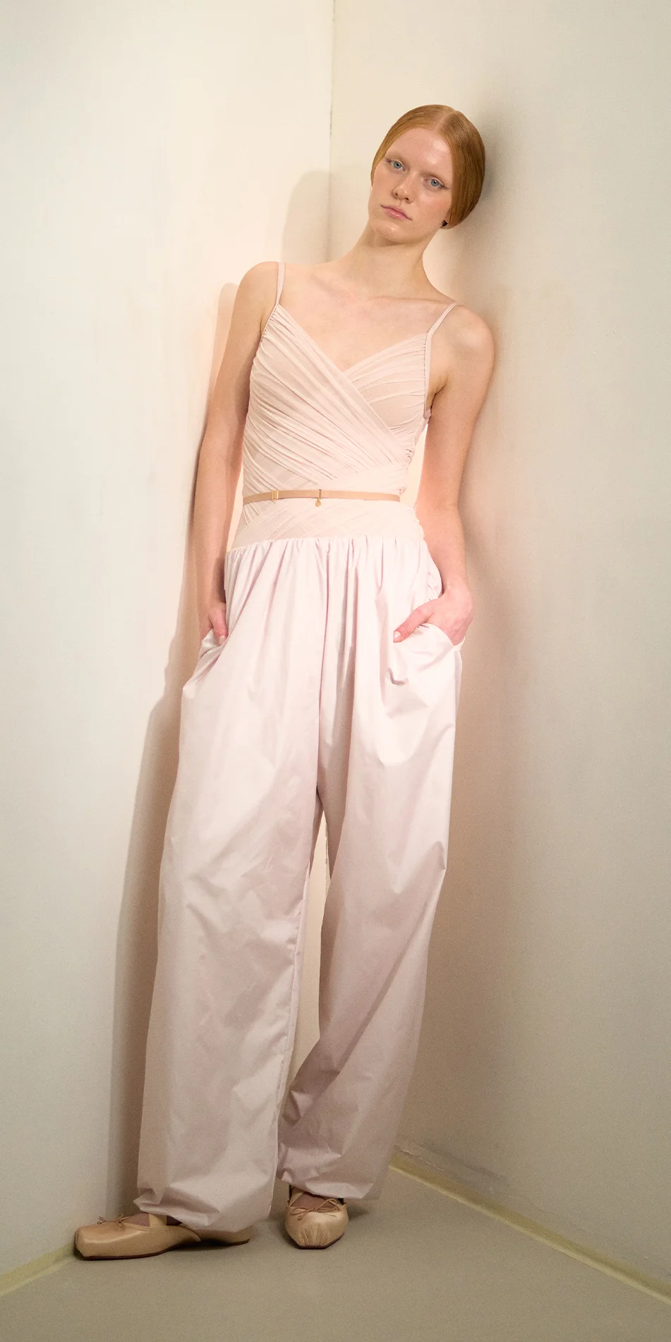 Women's lightweight baggy pants in soft pink front leaning on