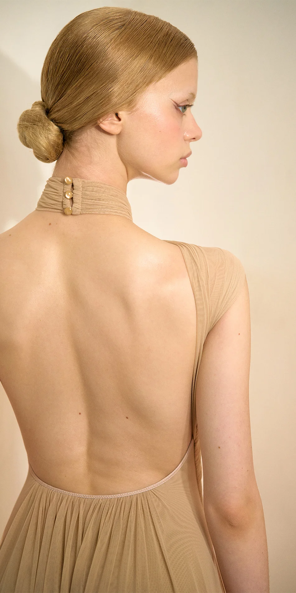 Knotted halter maxi dress in light beige back close up with model side profile