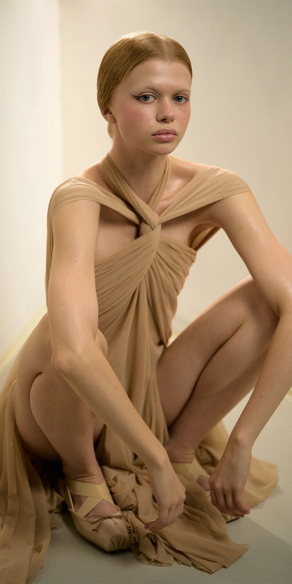 Knotted halter maxi dress in light beige model sitting with arms on the knees