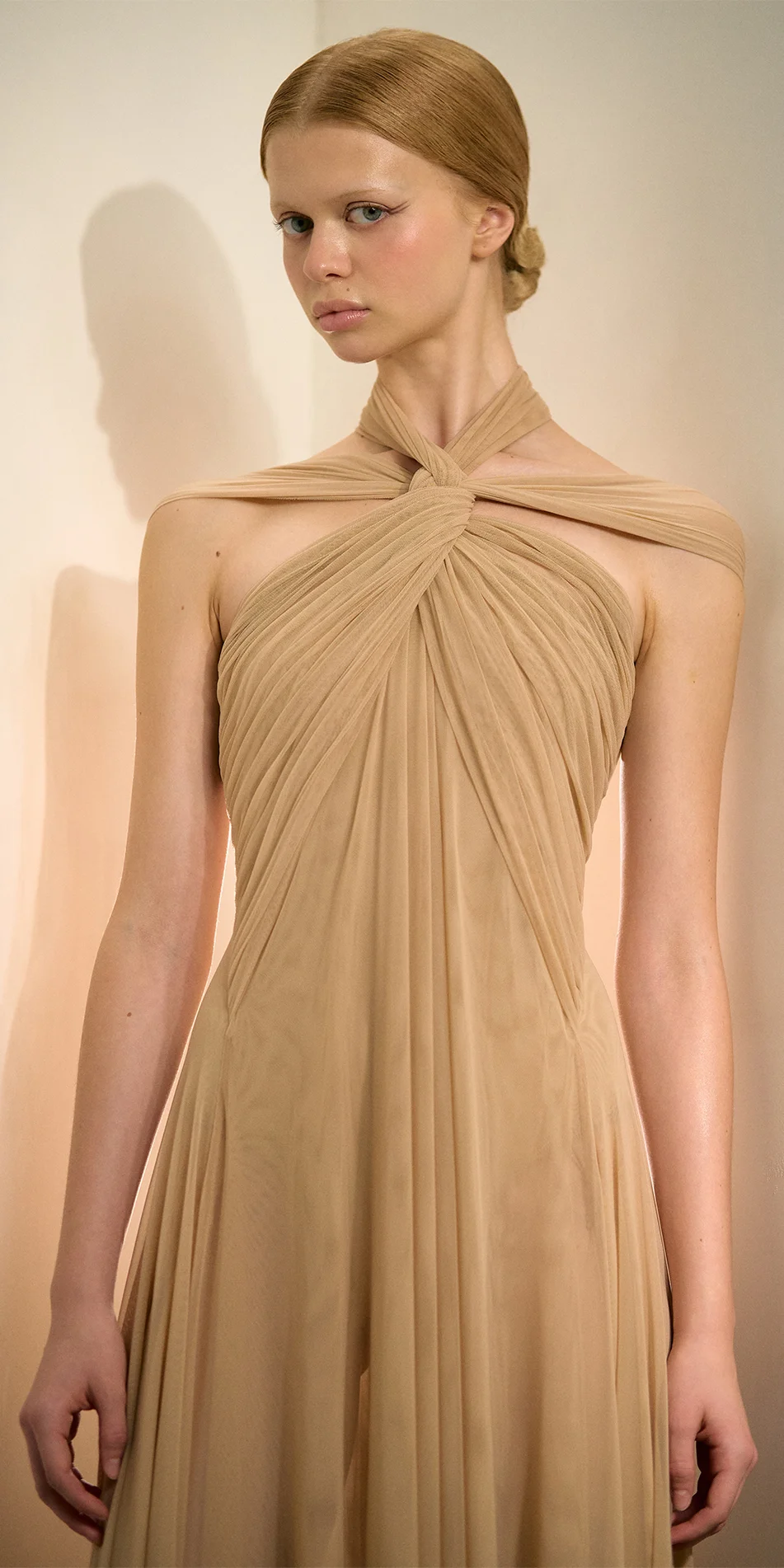 Knotted halter maxi dress in light beige upper medium shot with model gaze