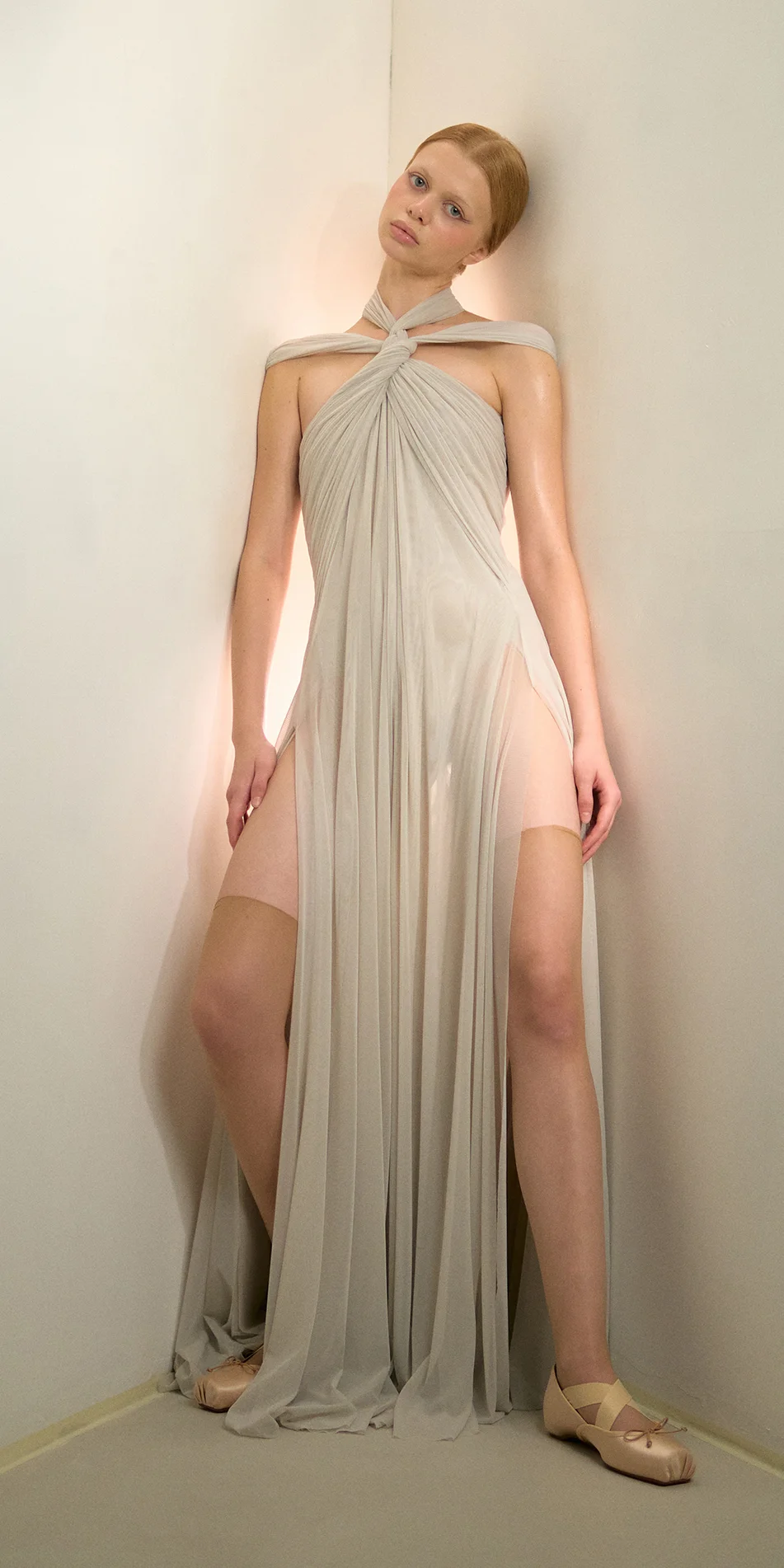 Knotted halter maxi dress in sage green front leaning on