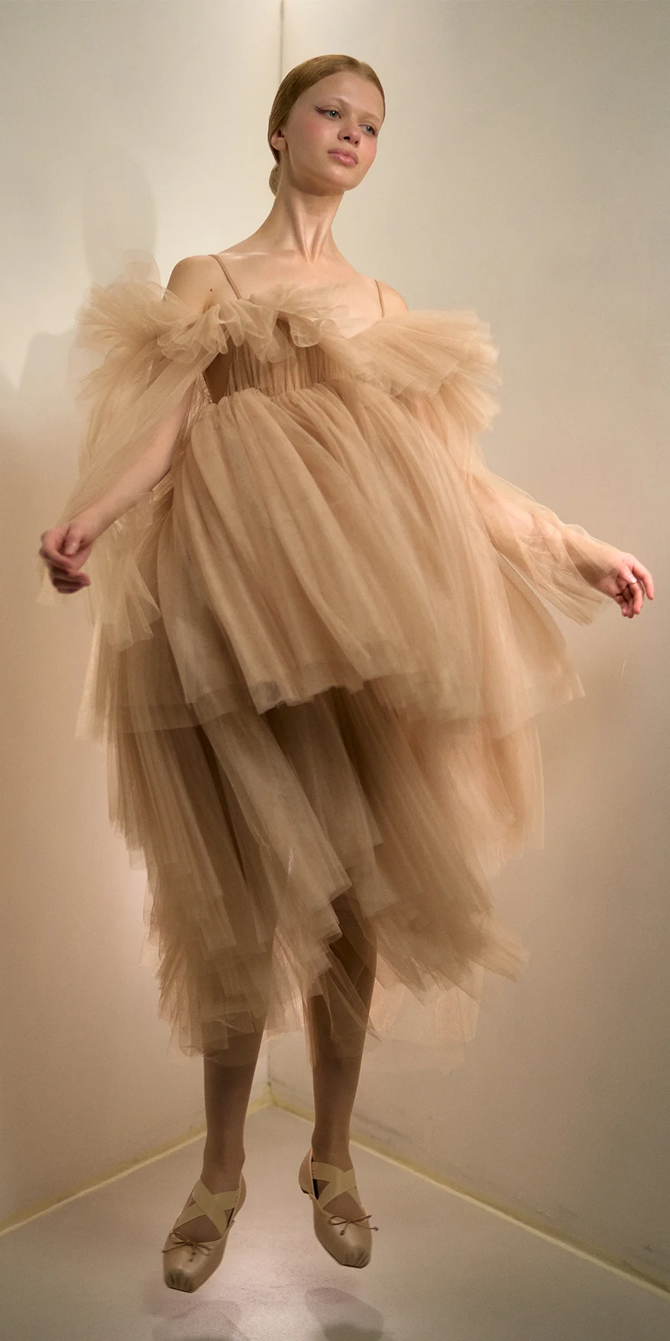 Tulle babydoll dress angel sleeves in light beige front jumping