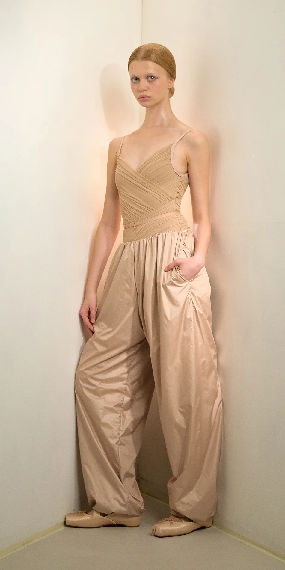 Womens lightweight baggy pants in light beige front hand in pocket on