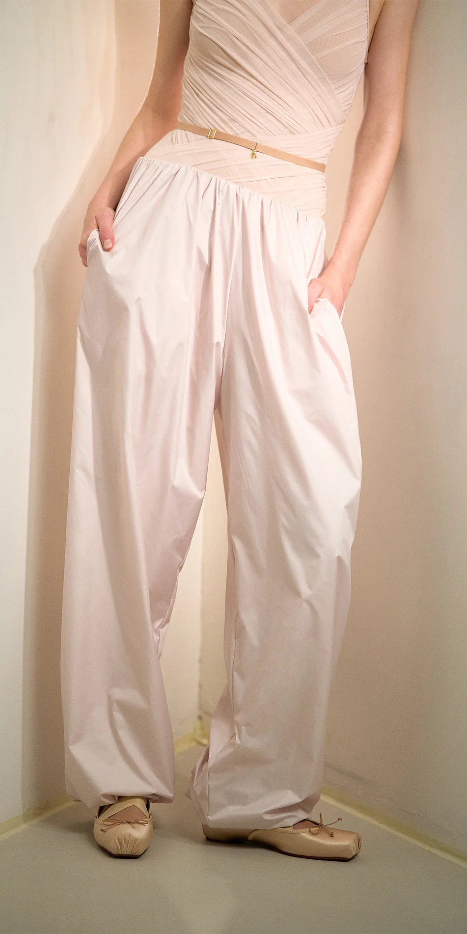 Women's lightweight baggy pants in soft pink front hands in pockets